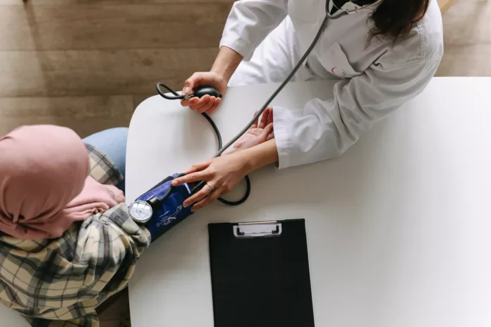 a doctor taking patient s blood pressure